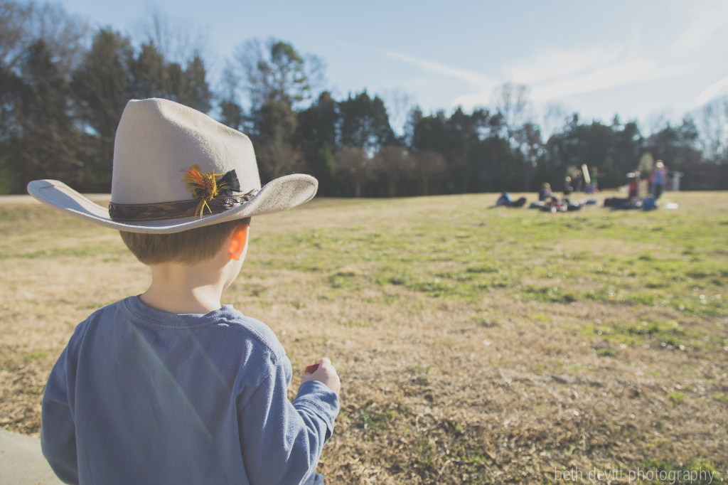 soaking up some sun {in cowboy mode, of course} while watching his big bro at golf practice.  