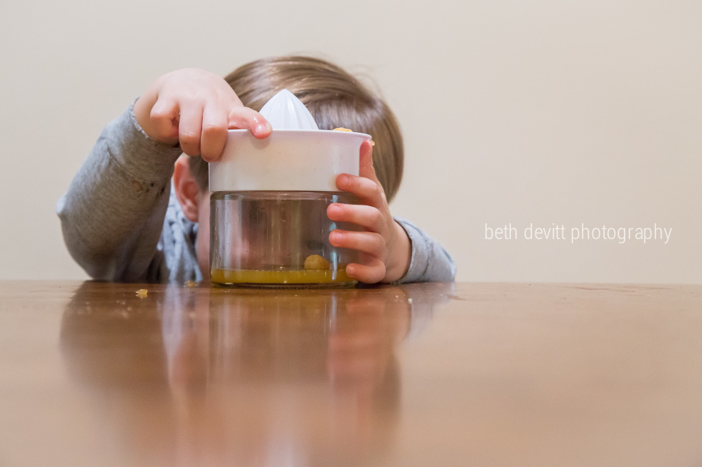 he was determined that his clementine would make enough juice to drink.  and he was right.  love this boy.