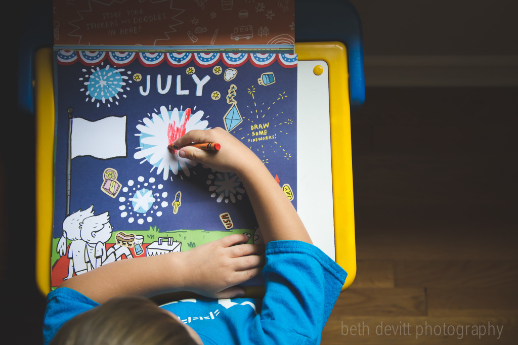 coloring the july picture in his calendar.  better late than never.  