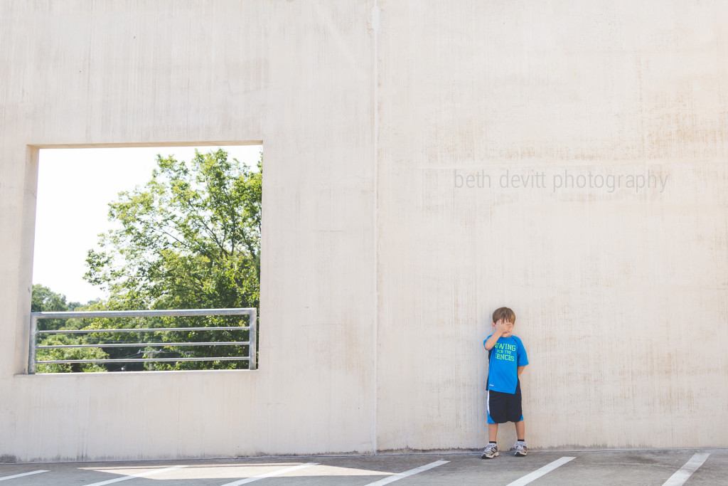 we visited the children's museum today, and he asked me to park at the top of the parking deck.  when we were heading home, we explored a little bit, but he thought we could get in trouble since we weren't going back into the museum.  hence, he kept his face covered.  ;)
