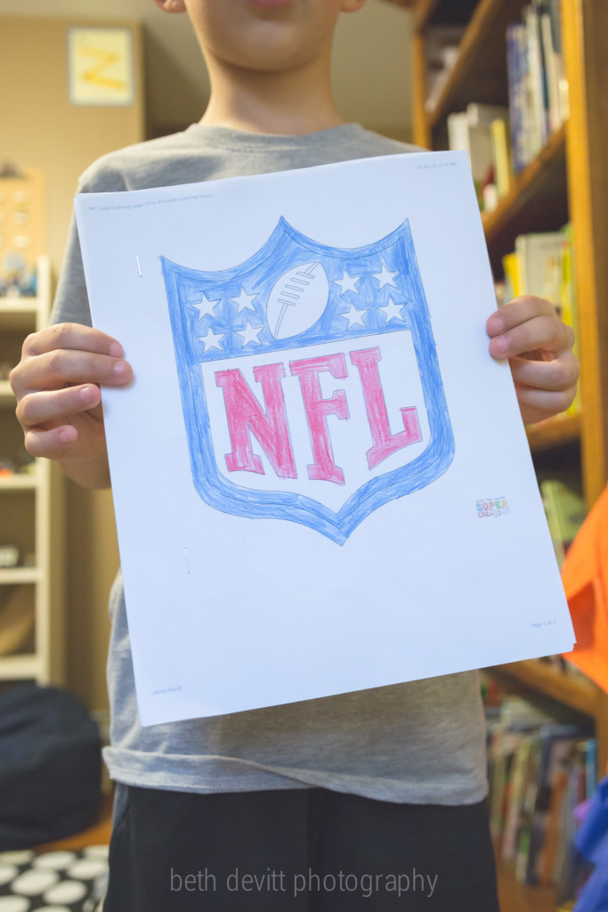 it was a rainy day.  he asked me to print out various football team logos to color.  and then he put them together to make an nfl book.  love.